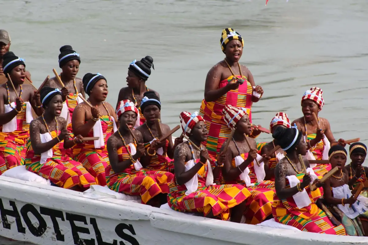 Singing and percussion performers in a festival canoe