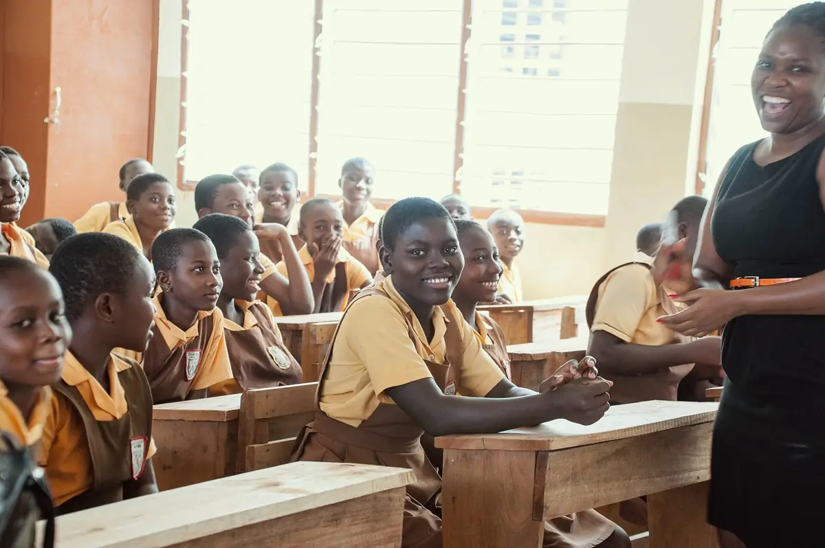 A teacher and pupils in a classroom at A and B Cluster Schools in Accra