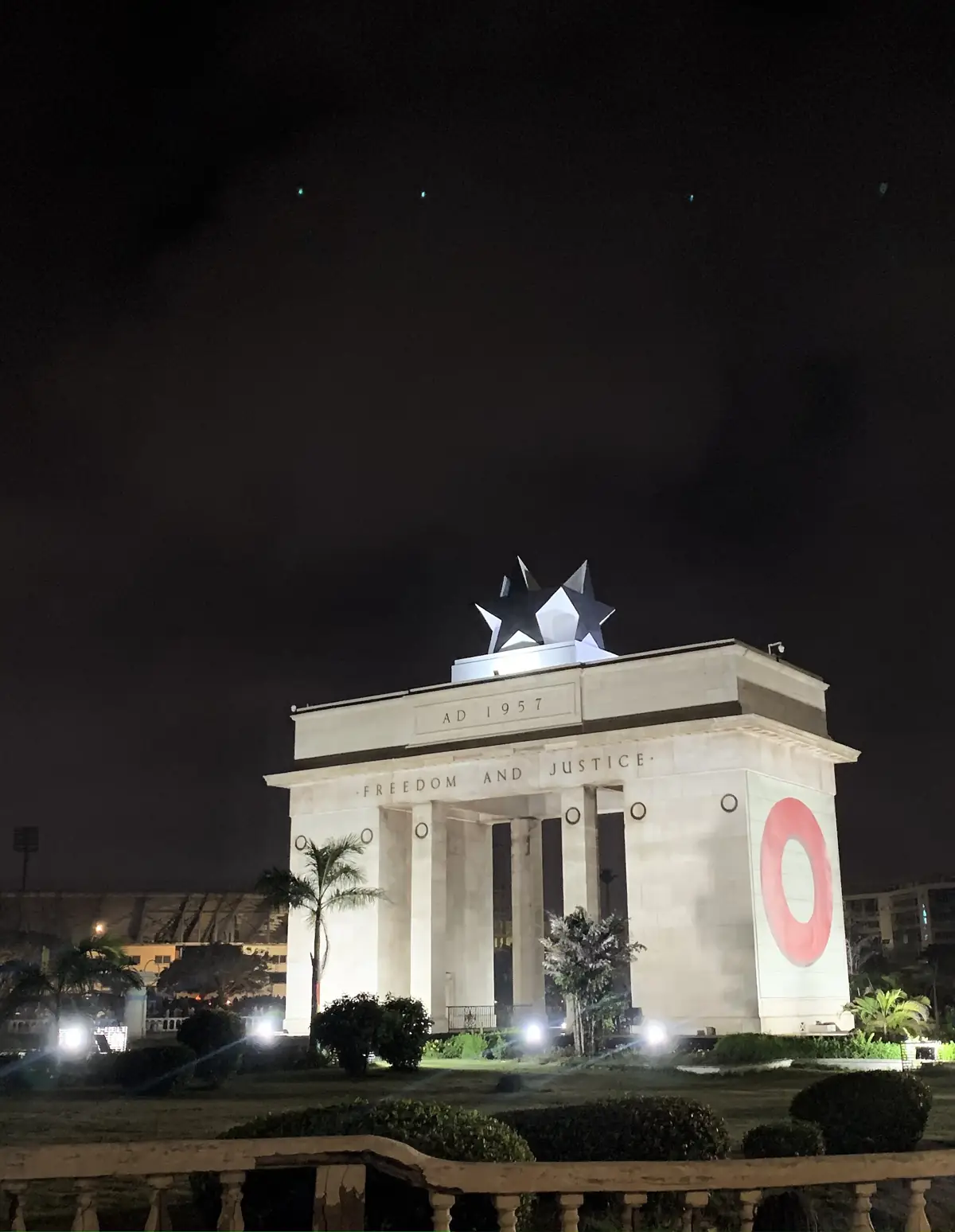 The illuminated Black Star Gate at Independence Square in Accra at night