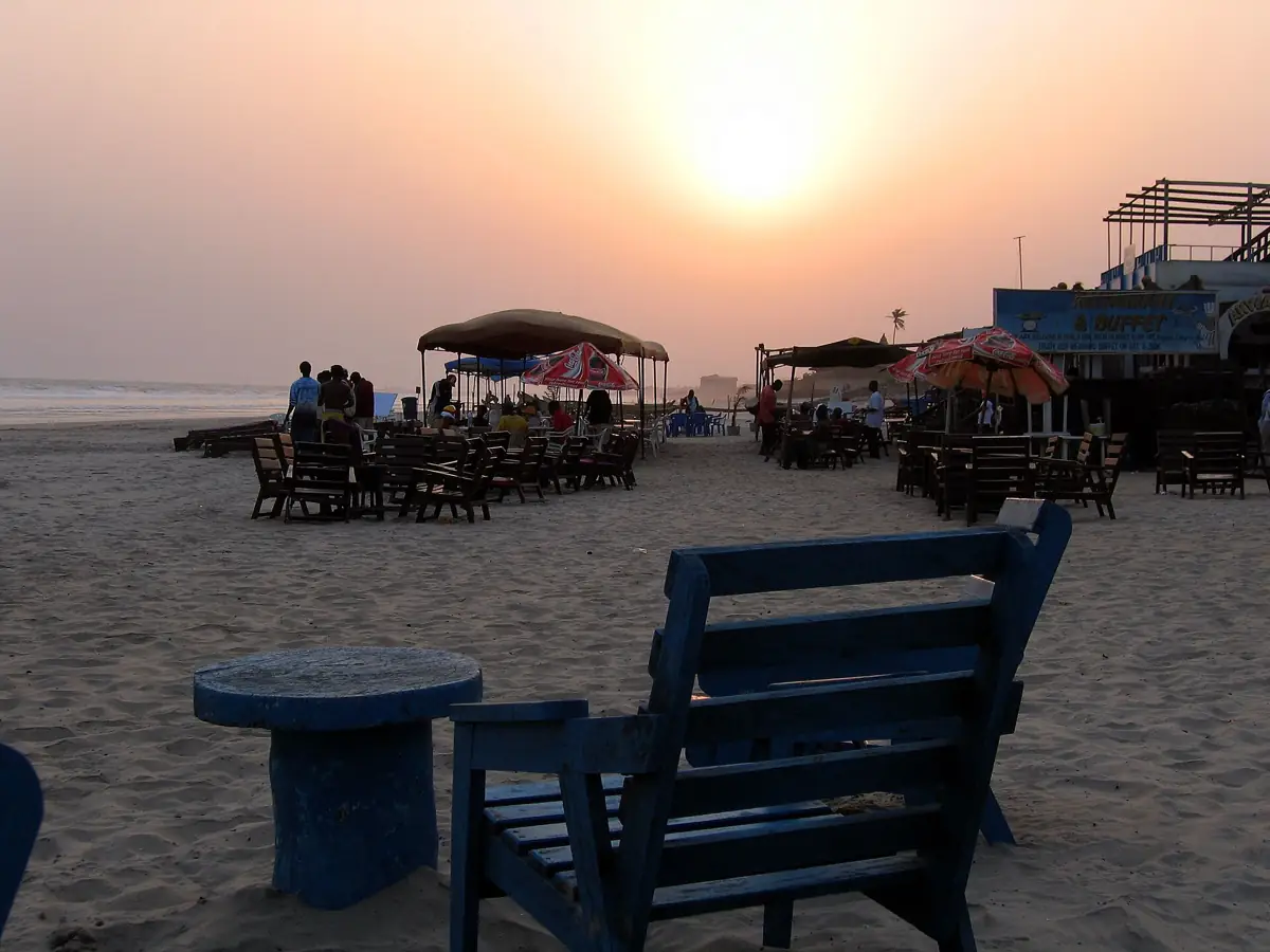 Beach chairs and umbrellas on Labadi Beach in Accra at sunset