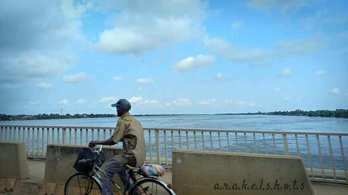 A waterfront view of Volta Lake beneath a bright blue sky