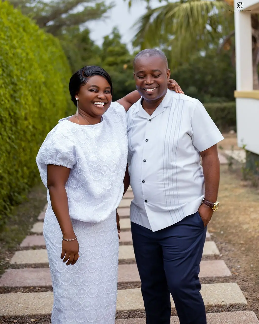 A smiling couple standing together outdoors
