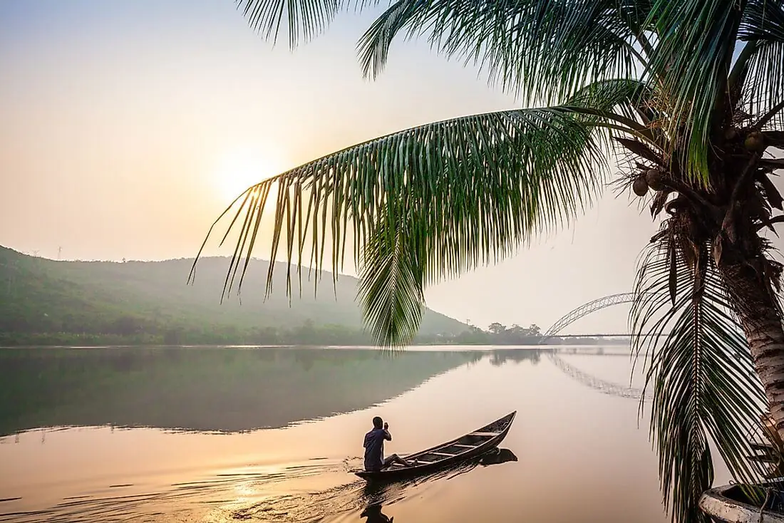 Sunset over water and a canoe